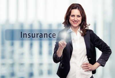 woman smiling while pointing insurance button
