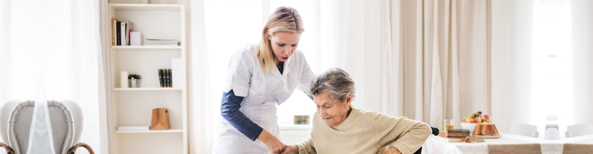 caregiver assisting the old woman